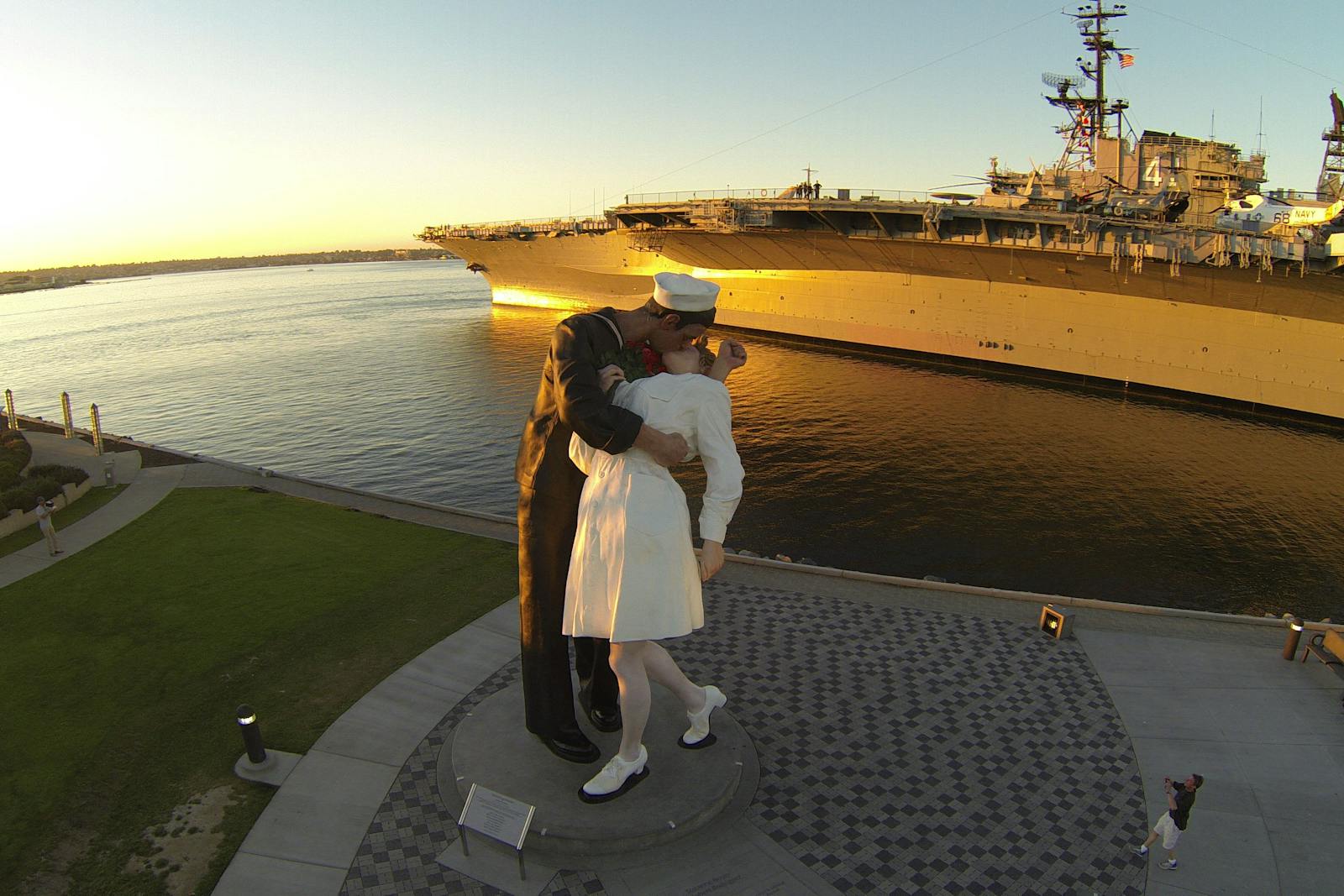Kysset-statyn framför USS Midway Museum vid solnedgång